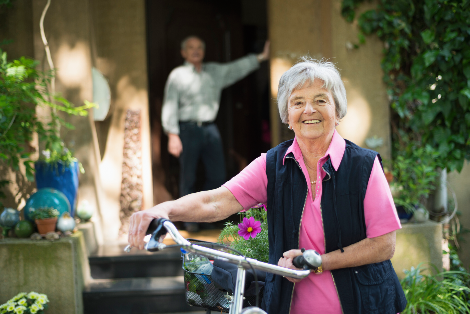 senior-woman-with-a-bike-in-front-of-a-house-smil-2024-07-10-20-08-02-utc